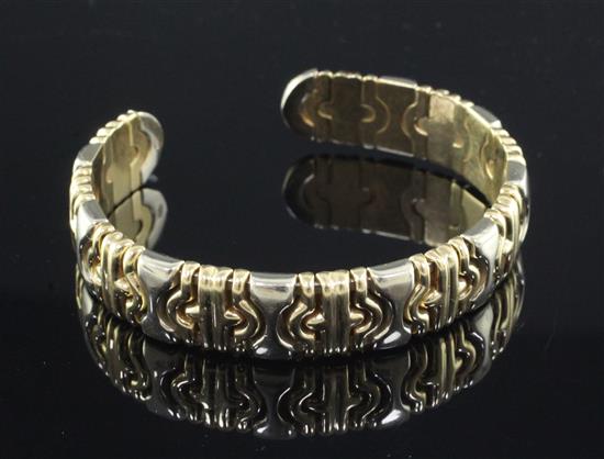 A stylish two colour 18ct gold open bangle.